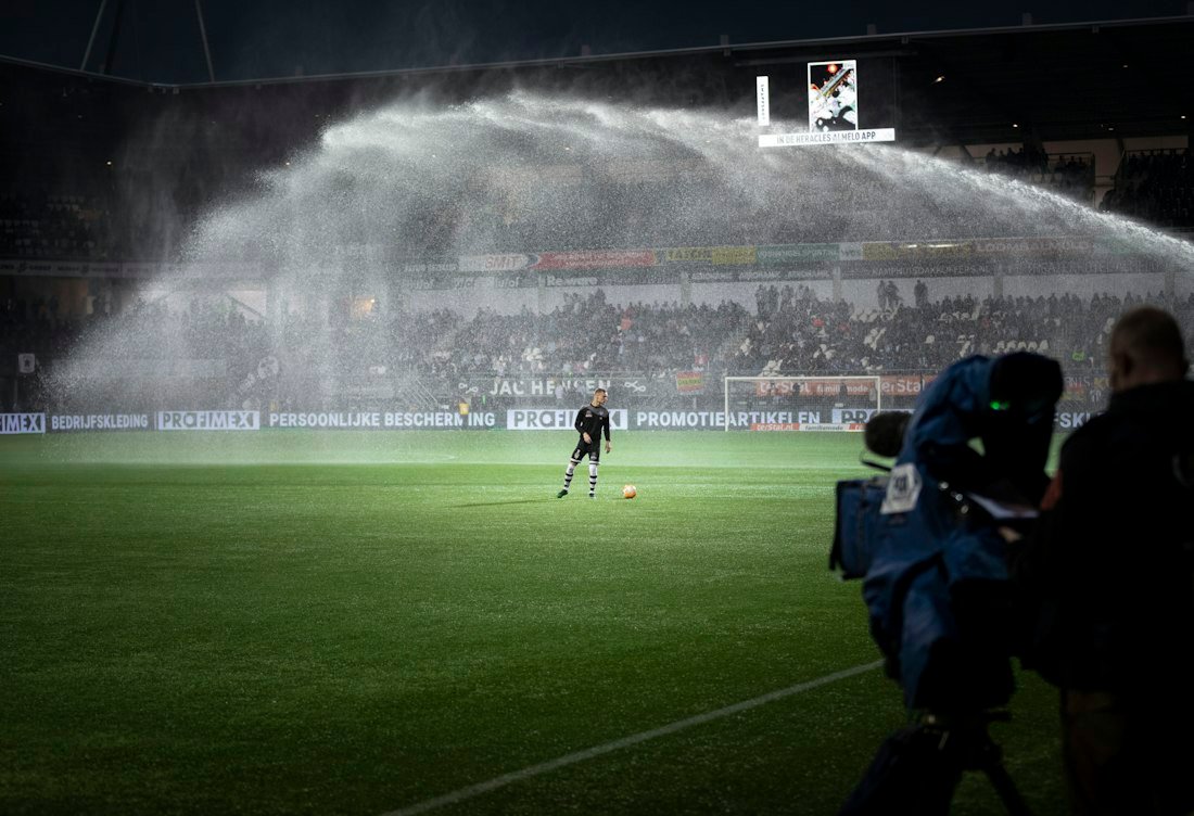 Pelouse arrosée par les arroseurs du stade